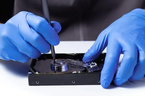 Repair Hard disk. Hands of master in gloves with screwdriver repair the compu Stock Photos