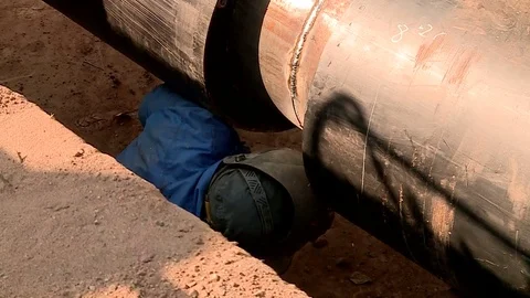The repair of the heating system worker welds a pipe Stock Footage 79551300