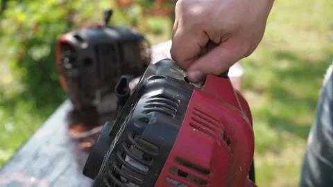 Repair of a lawn mower. a man changes a candle in a mower. replacement of the Stock Footage 168966092