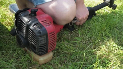 Repair of a lawn mower. the man pulls the starter cord. starts the mower Stock Footage 170822624