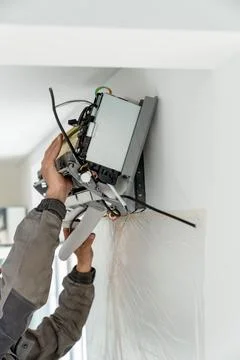 Repair maintenance of ventilated systems. Installation of air conditioner by Stock Photos