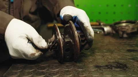 Repair an old rusty durty car turbine, disassembling the turbine, repairing and Stock Footage 284545366