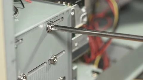 Repair a personal computer: disassemble a computer: unscrew a support screw Stock Footage 77769668
