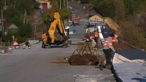 Repair of the road surface on the bridge. The workers put in a protective film Stock Footage 309759197