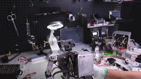 Repair the robot on the workbench Stock Footage 313836126