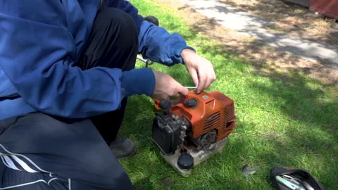 Repair String trimmer on grass Stock Footage 156337041