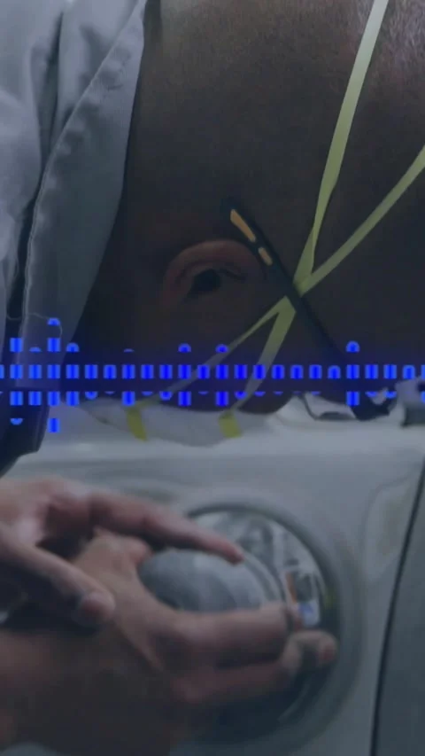 Repair tech leaning over white panel, touching dial and tightening as blue pixel Stock Footage 334386808