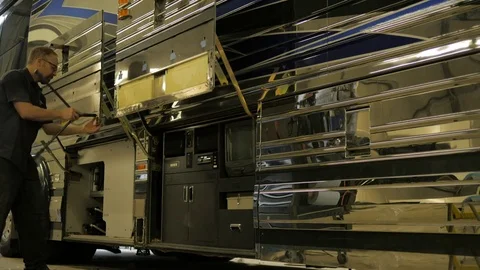 Repair technician replacing panels on a bus Stock Footage 73981380