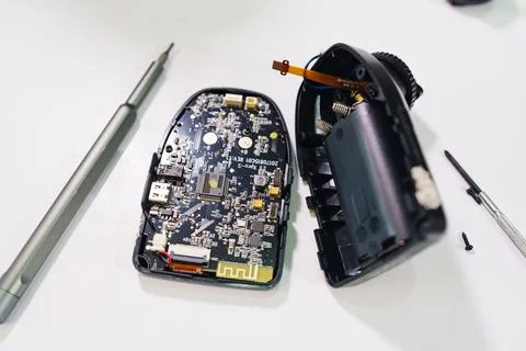 Repair work on electronic device and circuit board at a workspace Stock Photos