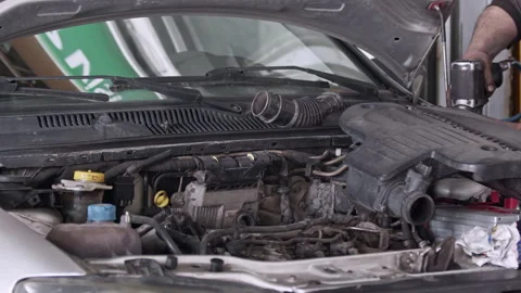 Repair Work in the Engine Compartment of an Old Car in a Repair Shop Stock Footage 304042675