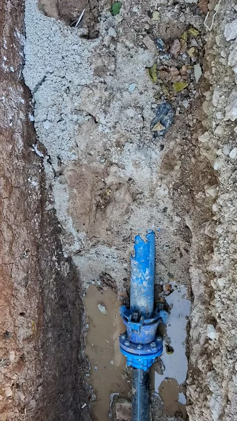 Repair work on a leaking water pipe in rocky ground began Stock Footage 337344668