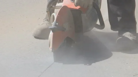 Repair work on the road. A worker saws asphalt. Stock Footage 131959801