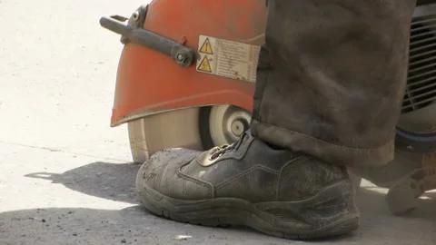 Repair work on the road. A worker saws asphalt. Stock Footage 131960620