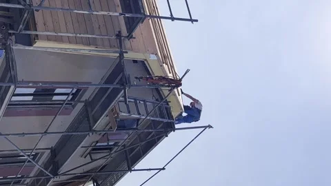 Repair work on the roofing of the house. The builder works on the top of the Stock-Footage 250113201
