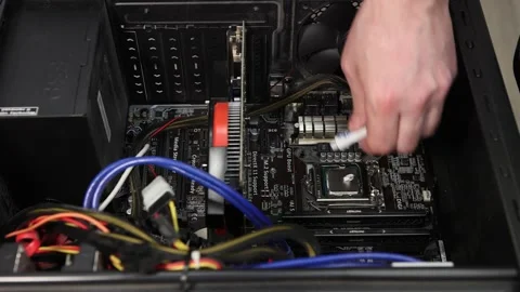 Repairer applies protective thermal paste to computer processor chip. Stock Footage 146705860