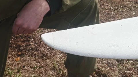Repairing of broken drone wing. Man wipes glue remainings from a wing. Stock Footage 168236249