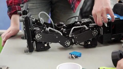 Repairing a broken robot with a screwdriver. Stock Footage 167361729