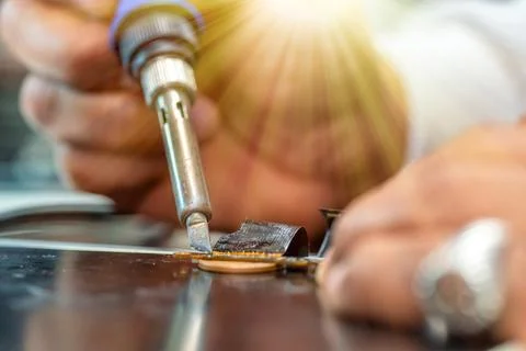 Repairing computer connector in electronics lab with precision tools close-up Stock Photos