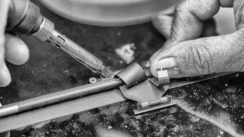 Repairing computer connector in electronics lab with precision tools close-up 写真素材
