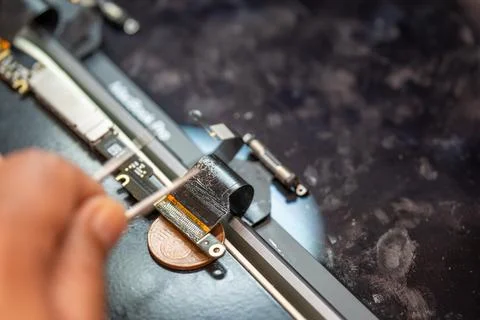 Repairing computer connector in electronics lab with precision tools close-up 写真素材
