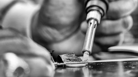 Repairing computer connector in electronics lab with precision tools close-up 写真素材