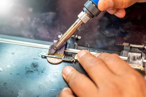 Repairing computer connector in electronics lab with precision tools close .. 写真素材