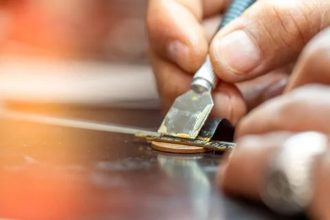 Repairing computer connector in electronics lab with precision tools close-up 写真素材