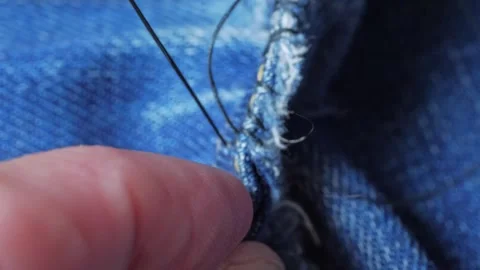Repairing denim with thread and needle close-up 動画素材 281503950