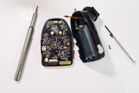 Repairing electronics circuit board with tools on a white surface Stock Photos
