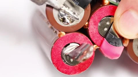 Repairing electronics with focus on battery connections and soldering Stock Footage 333246765