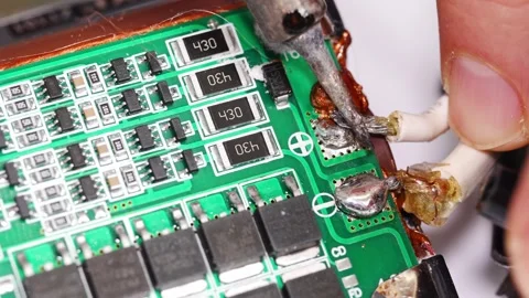 Repairing electronics with soldering and precision tools at workshop Stock Footage 333246926