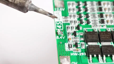 Repairing electronics by soldering a circuit board in a workshop Stock Footage 333246326