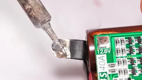 Repairing electronics with soldering skills in an electronics workshop Stock Footage 333246792