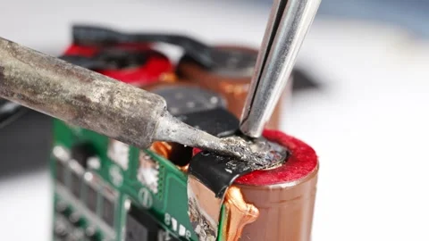 Repairing electronics with soldering technique for battery packs Stock Footage 333246676