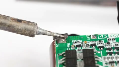 Repairing electronics with soldering technique in workshop setting Stock Footage 333246669