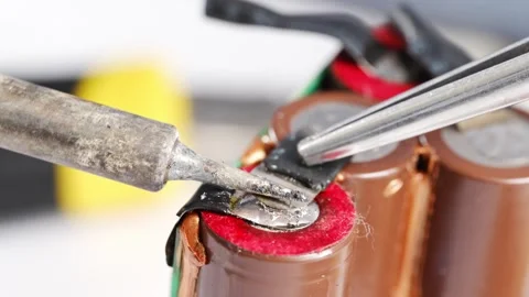 Repairing electronics with soldering techniques for batteries Stock Footage 333246608