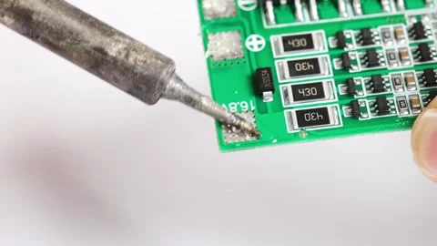 Repairing electronics with soldering techniques at the workshop Stock Footage 333246401