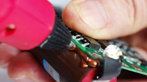 Repairing electronics with a soldering tool in hands-on activity Stock Footage 333246503