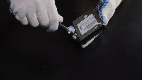 Repairing hard drive disk process. Opening HDD case with screwdriver Stock Footage 116654613