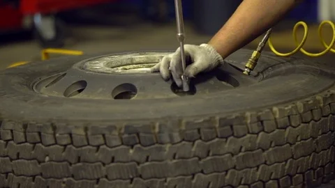Repairing wheel by a mechanic. Old wheel repearing Stock-Footage 82708853
