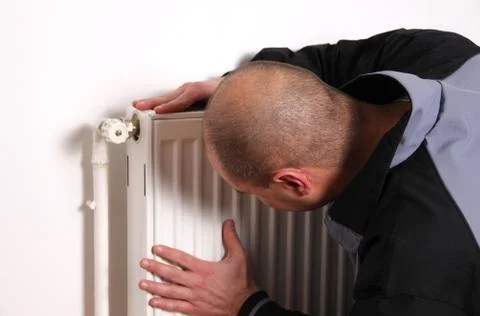 Repairman checking the radiator Foto stock