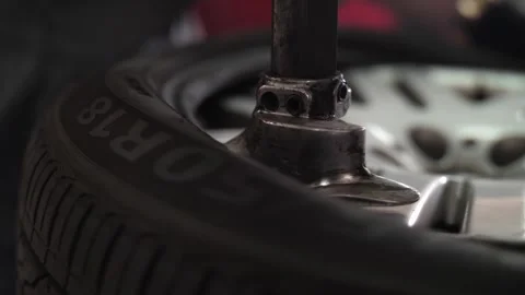 Repairman clamp wheel disk in fitting machine to remove rubber tire. Video stock 262546532