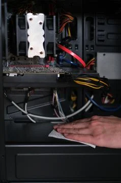 Repairman cleans the computer system unit from dust close-up Fotos de archivo