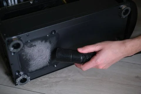 Repairman cleans the computer system unit from dust close-up Stock-Fotos