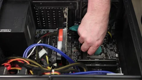 The repairman cleans the old thermal paste from the computer processor chip. Stock Footage 146705754