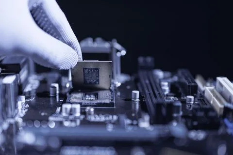 Repairman computer Installation CPU on socket of the motherboard. Stock Photos