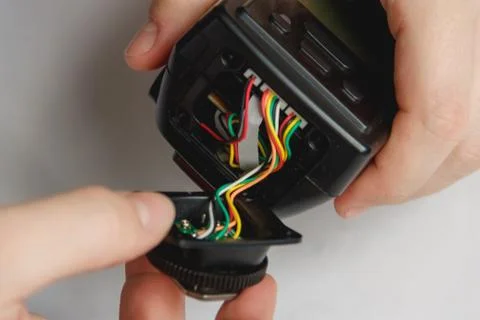 Repairman disassembling flash with screwdriver. Technician fixing broken Stock Photos