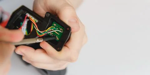 Repairman disassembling flash with screwdriver. Technician fixing broken Stock Photos