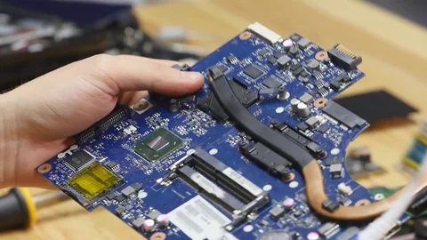 Repairman disassembling laptop motherboard. Engineer fixing broken computer at 動画素材 73626296