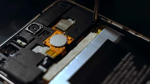 Repairman disassembling smartphone with screwdriver. Technician fixing broken Stock Footage 143166554